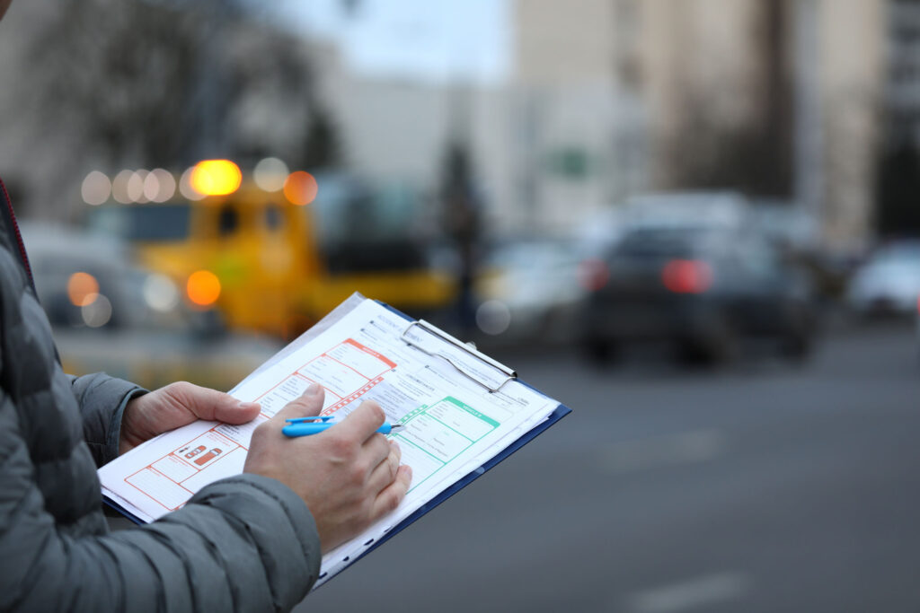 Recording a crash report beside the road